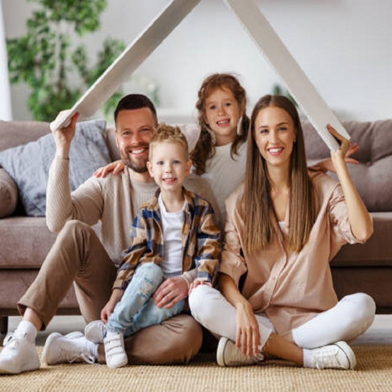 concept housing a young family. mother father and children under fake roof in a new home during relocation